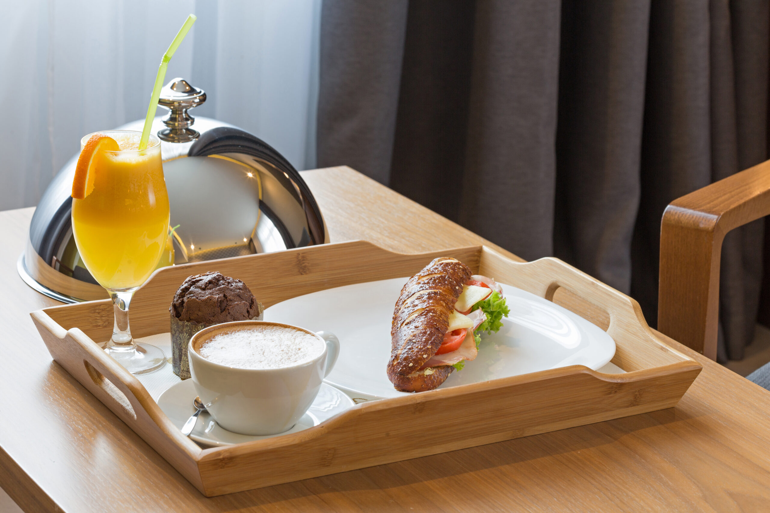 Breakfast in bed, hotel bedroom interior