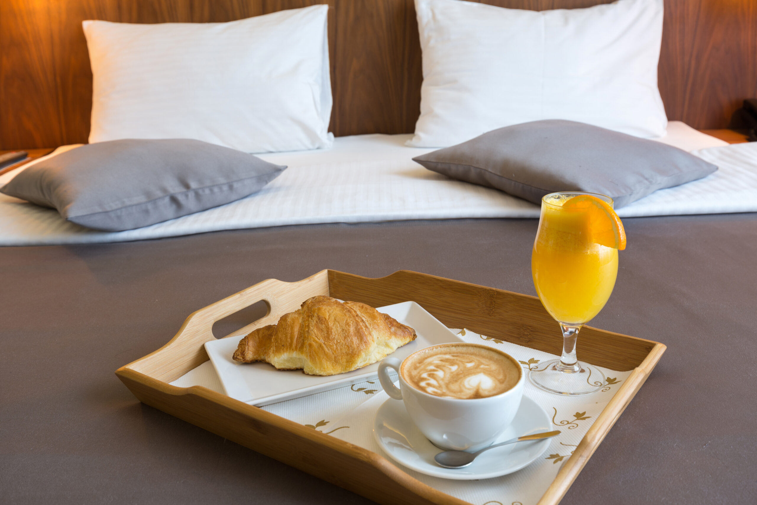 Breakfast in bed, hotel bedroom interior